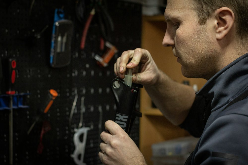Technician inspecting a tool part in the repair shop