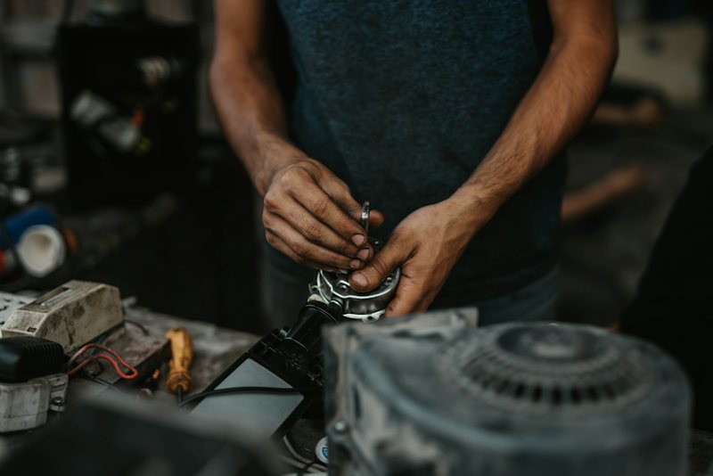 Technician holding a tool component on the bench